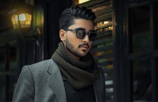 Man wearing shade and a suit with gel in his hair