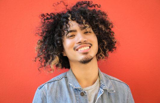Man with curls and subtle blonde highlights