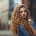 Woman with long blonde, wavy curls