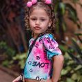 Little girl wearing pink pom poms hairstyle