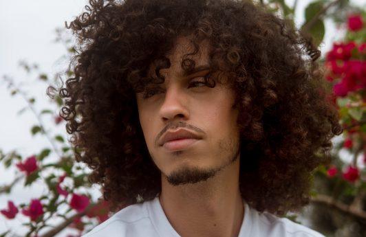 man perm: man with long tightly curled hair