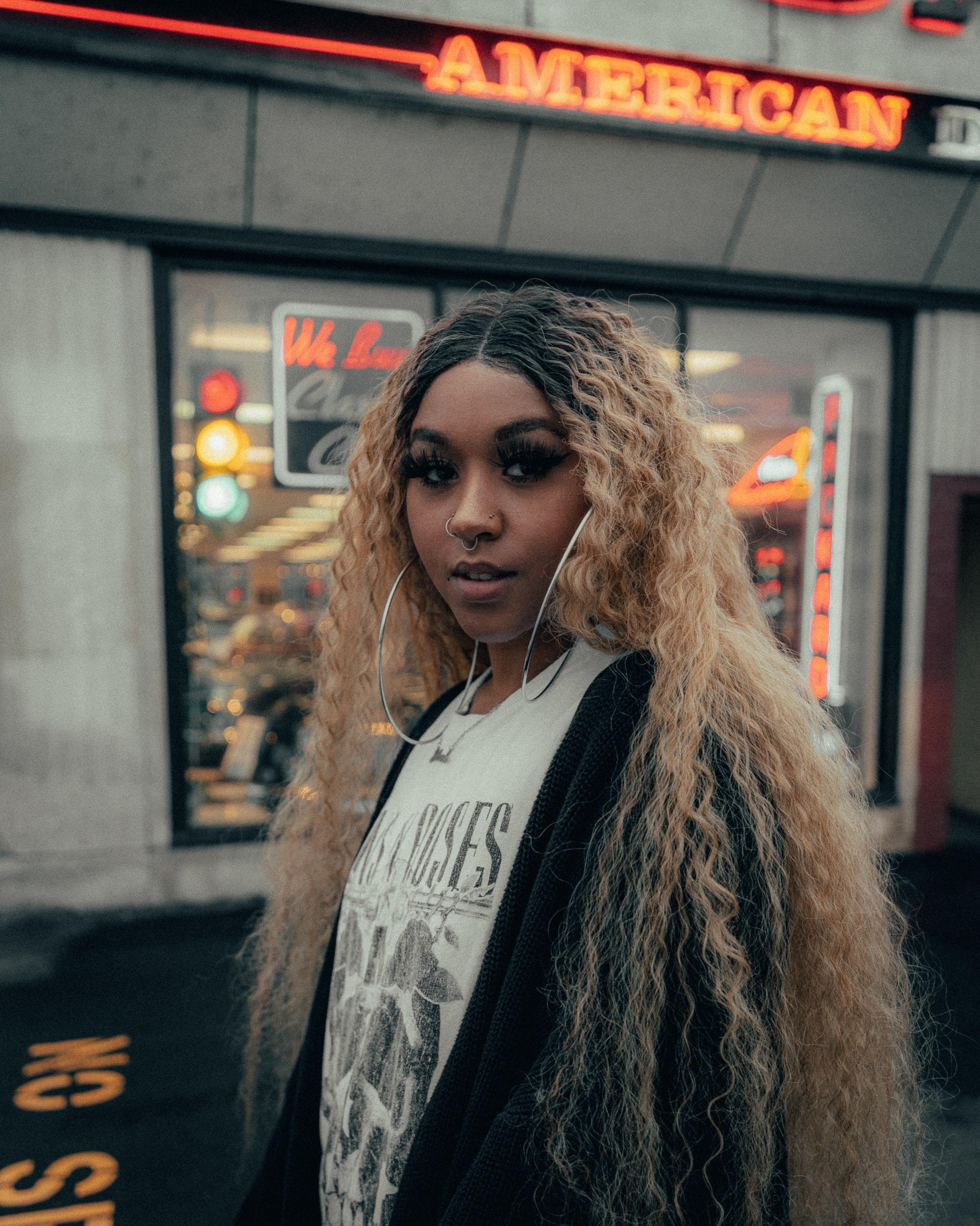 woman with very longe blonde hair with natural curls and dark roots