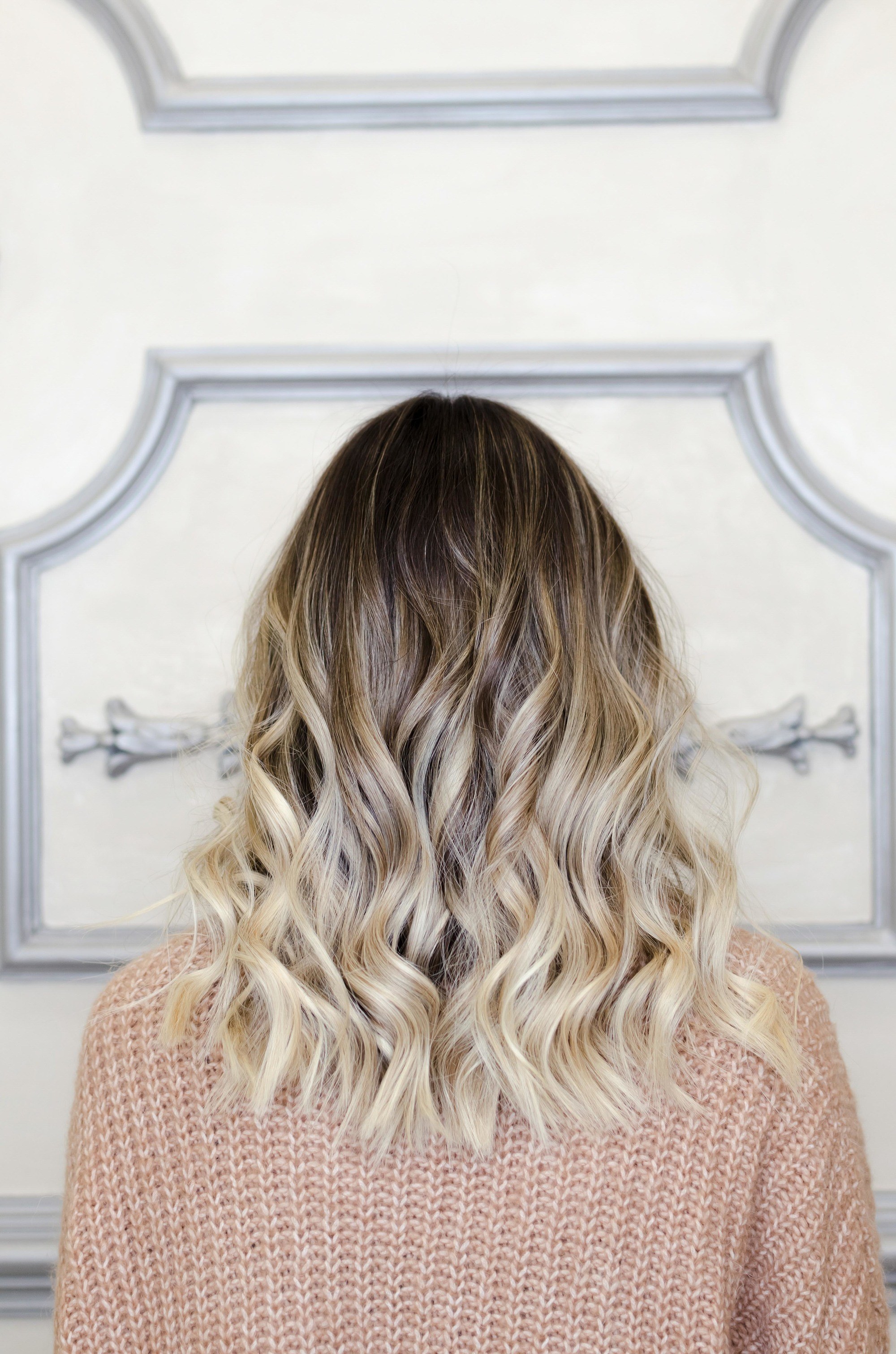 curly blonde hair with dark roots