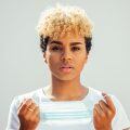 woman with short curly hair that's blonde on top and black on the sides
