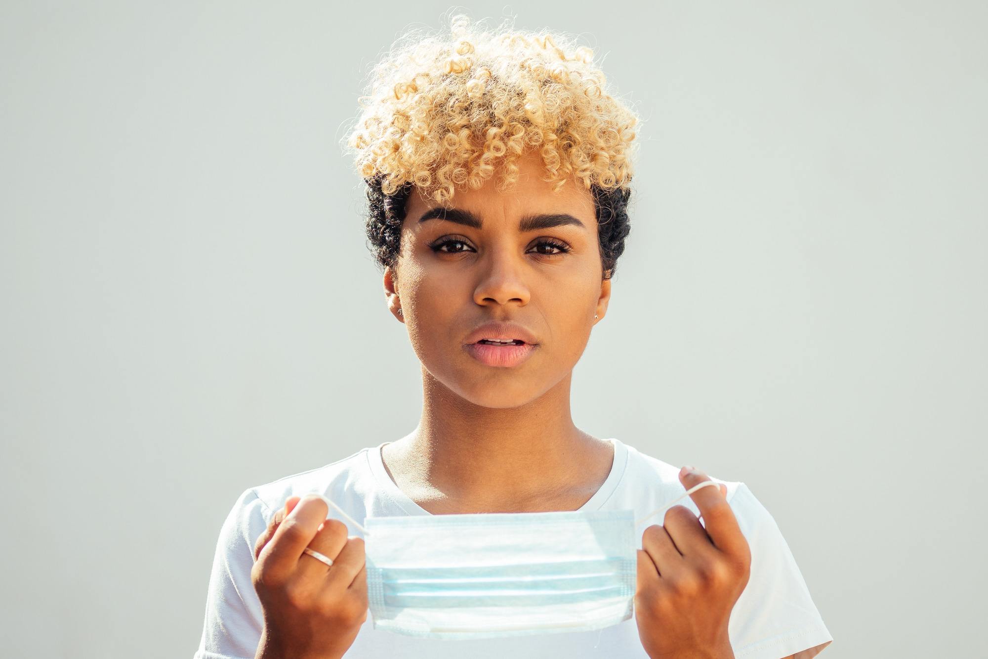 woman with short curly hair that's blonde on top and black on the sides