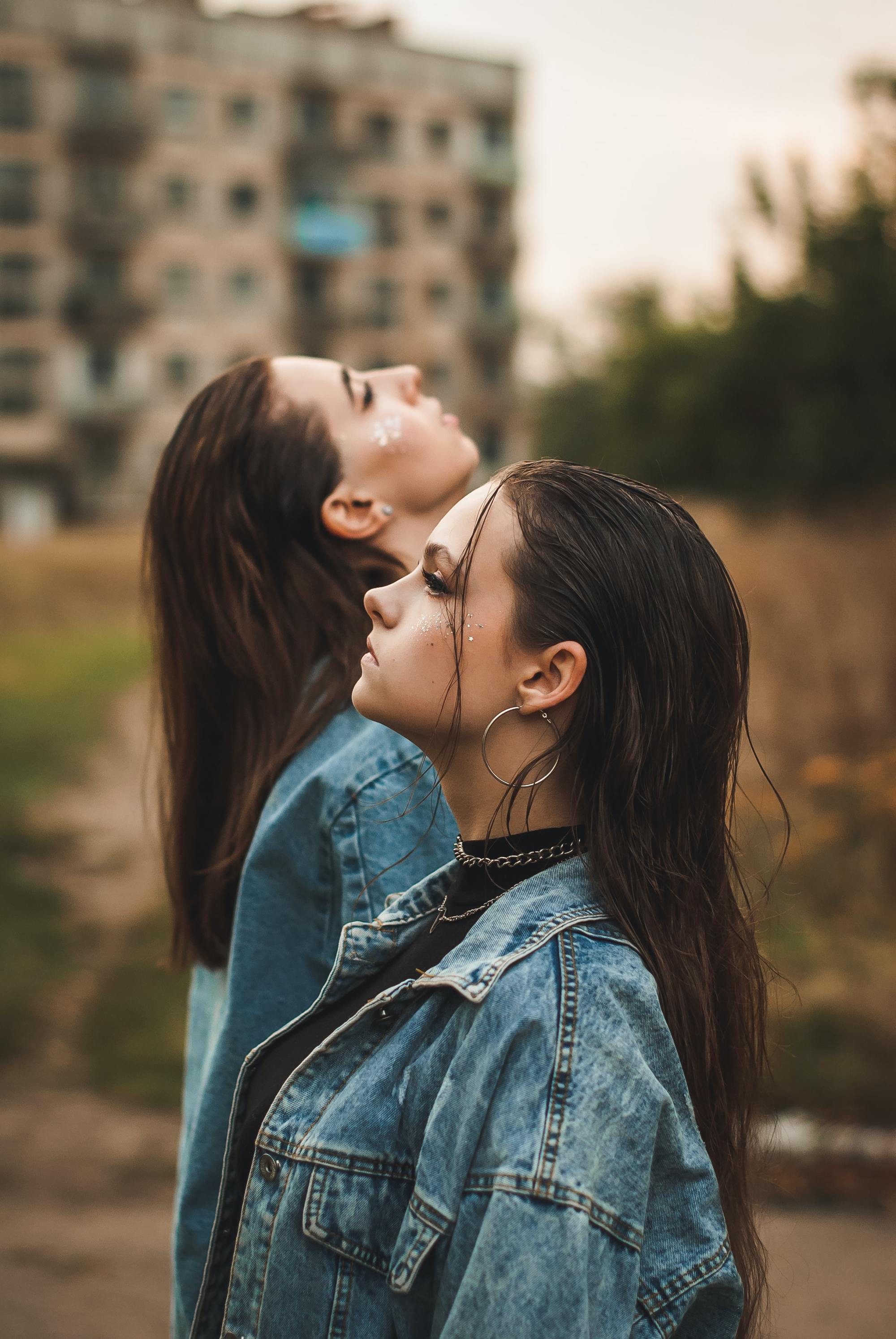 two women with long dark brown hair swept back into a wet look hairstyle