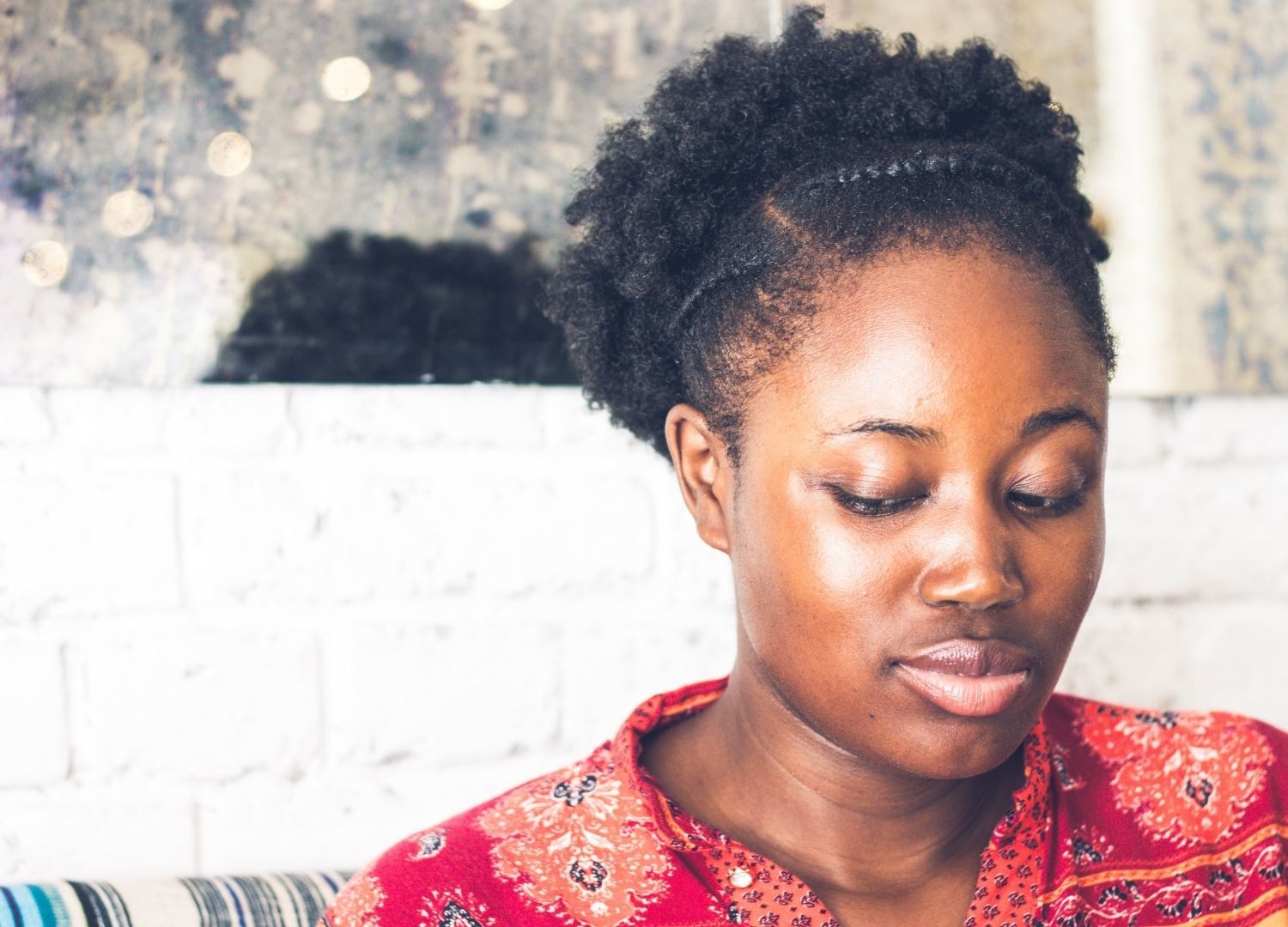 woman with natural 4c hair, with a braid along the front hairline