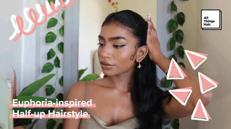 woman with a Euphoria-inspired hairstyle: half-up wavy hair with gelled baby hairs