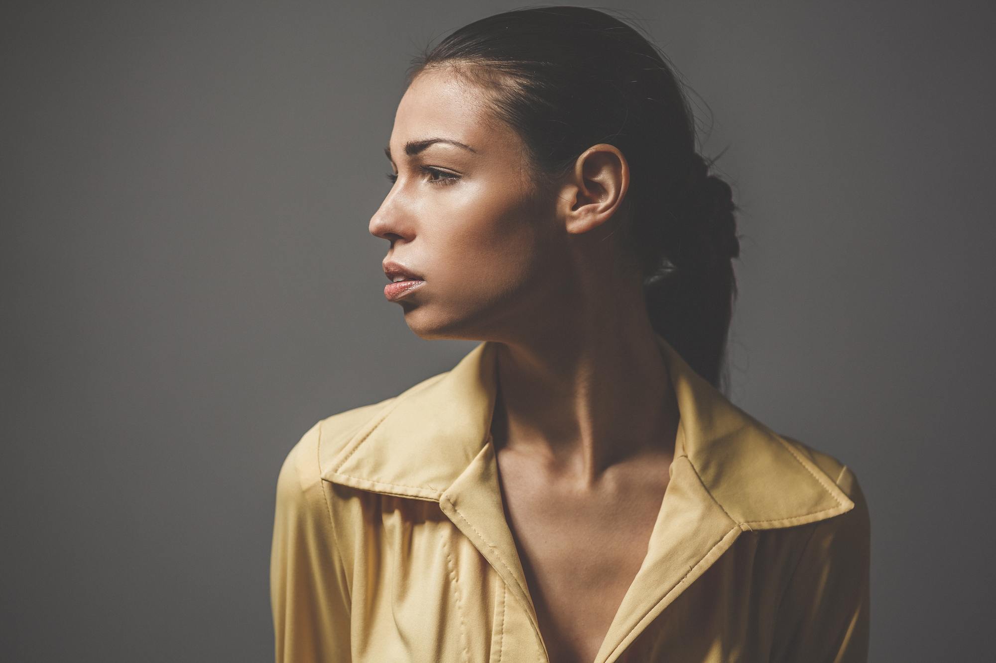woman with a sleek ponytail hairstyle with a plait