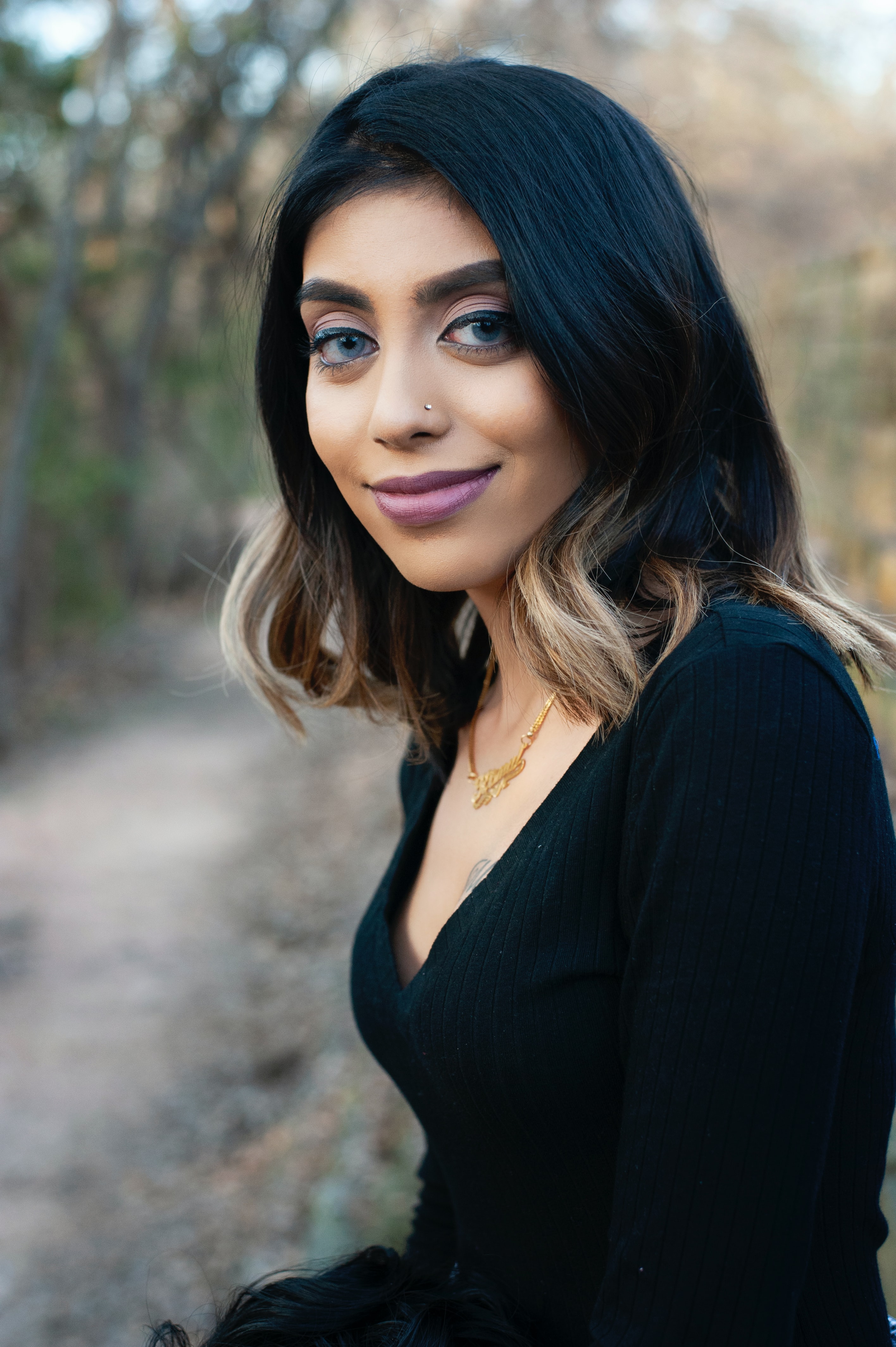 hair colour inspiration: woman with medium-length black hair with blonde ombre tips