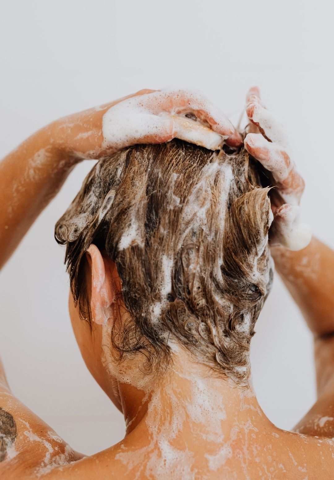 close-up image of a woman washing her hair