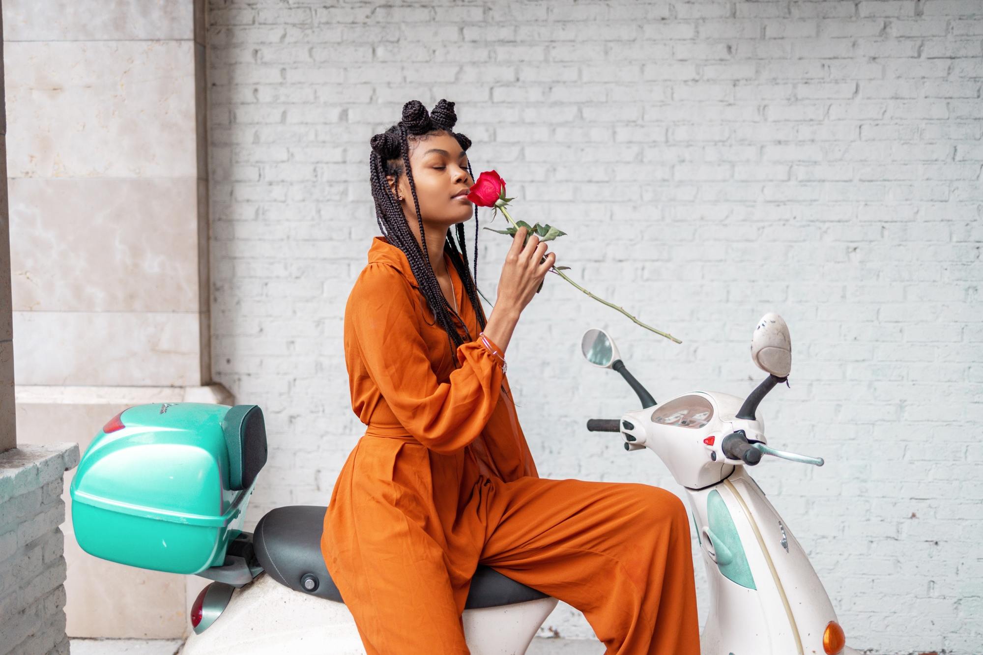 winter hairstyles: woman with long braids and mini buns tied along the front hairline