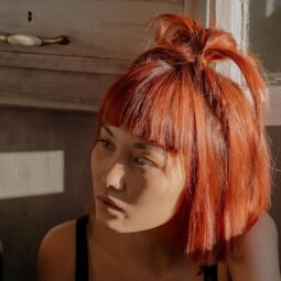 Kpop inspired hairstyle: woman with short bob hairstyle; hair dyed vibrant orange