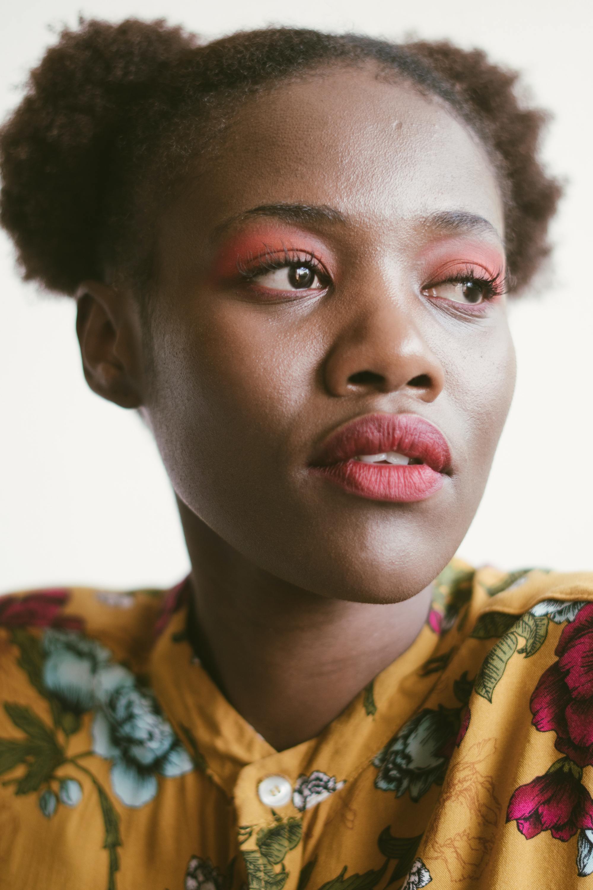 flawless hair: woman with natural 4c hair tied into two space bun puffs