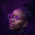 woman with locs tied up into a high bun hairstyle