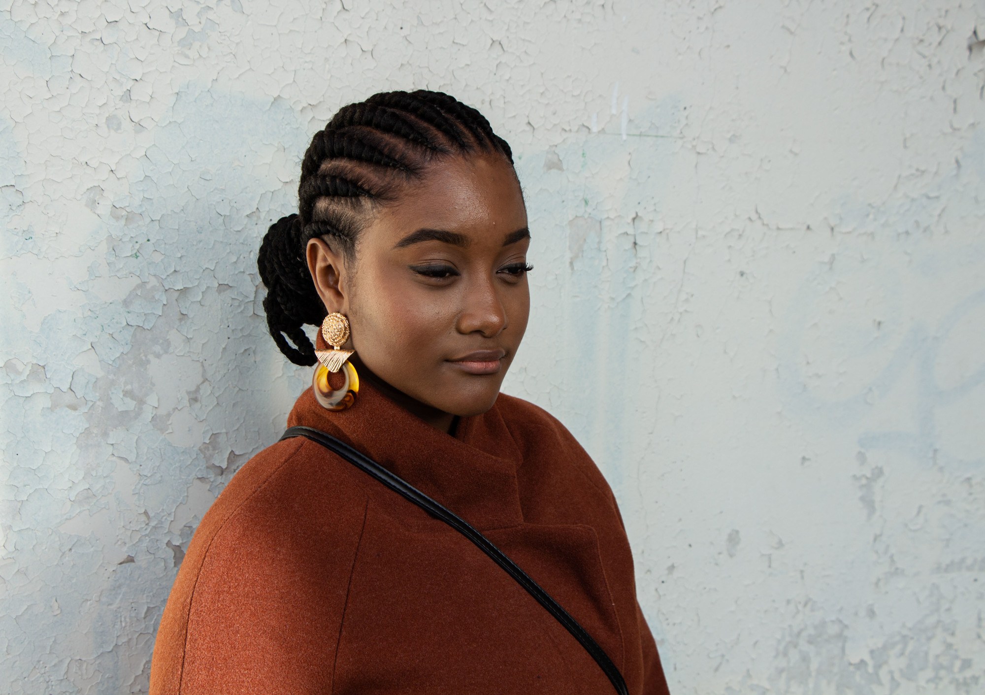 protective hairstyles: woman with cornrows hairstyle, braided backward in straight lines