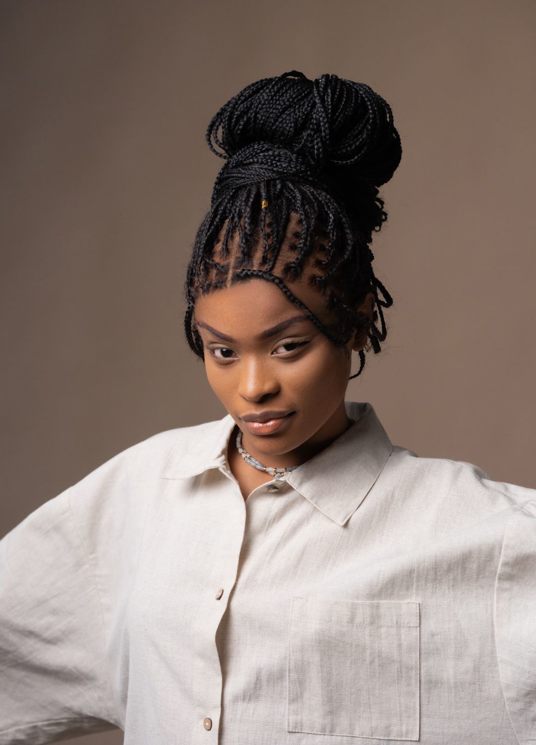 woman wearing her hair in braids, and tied up into a bun