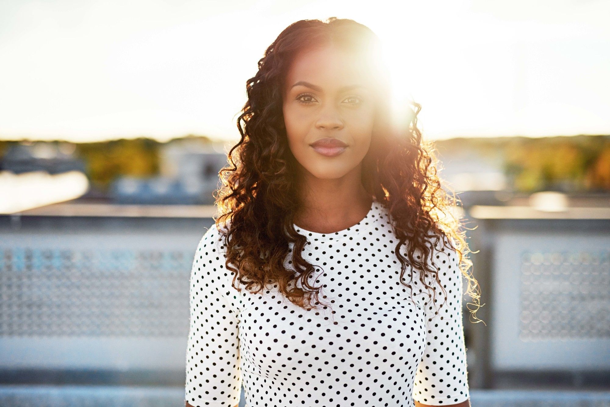 woman with naturally curly hair, styled with a middle path
