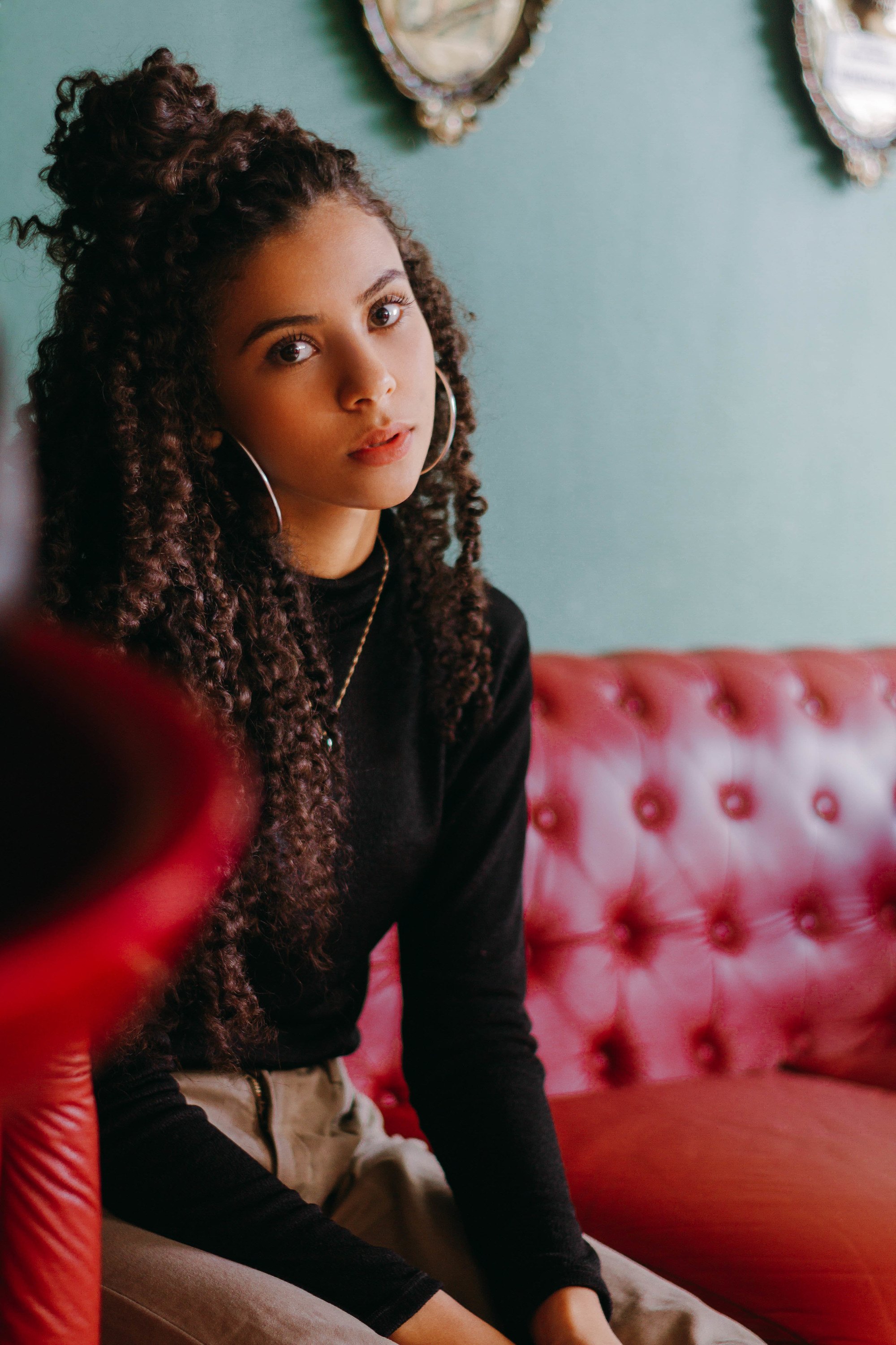 matching hairstyle ideas: woman with curly brown hair, with the top half tied up