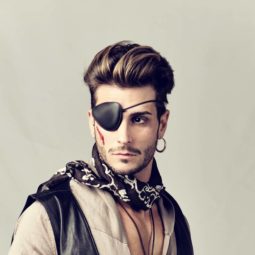 Homem se veste de pirata e usa cabelo pra trás com pomada, um dos penteados para homens no Carnaval