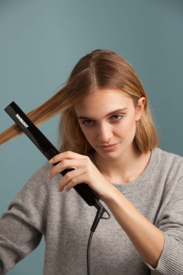 Straightening long copper hair