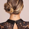 a rear view of a woman with side braided bun chignon hairstyle
