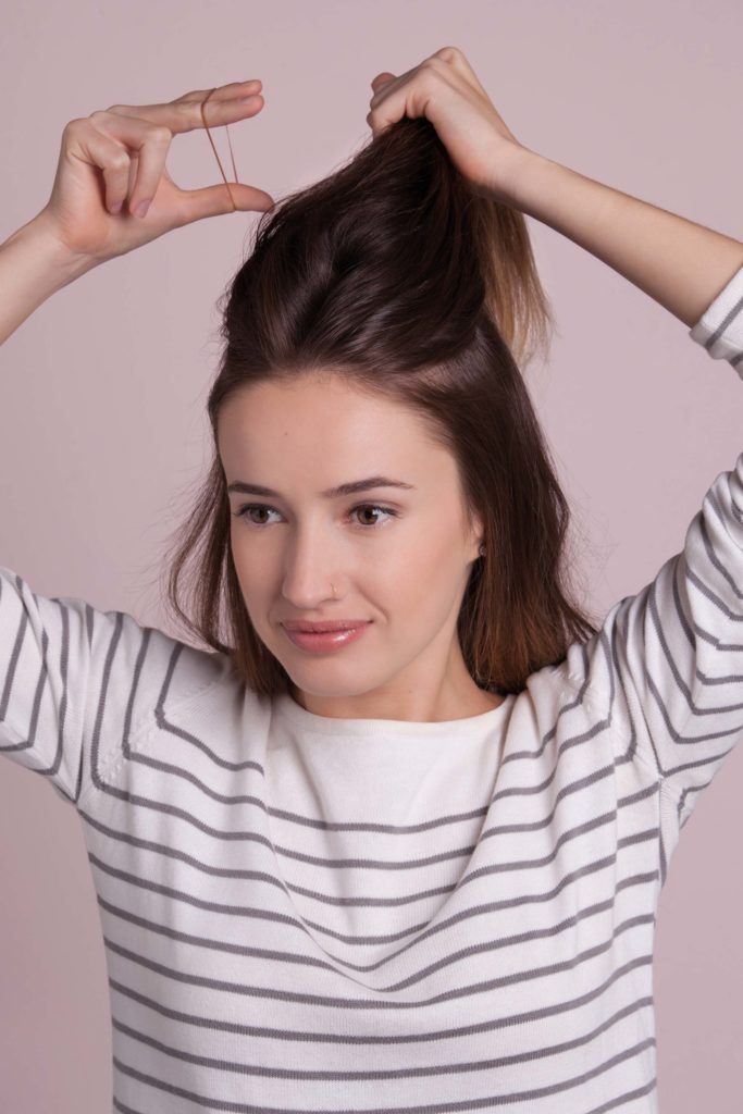 the french braid updo starts by gathering the top section