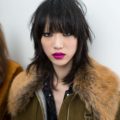 a picture of japanese woman with blunt bangs hairstyles wearing a furry coat
