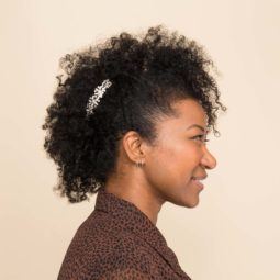 an afro woman with mohawk hairstyle side view