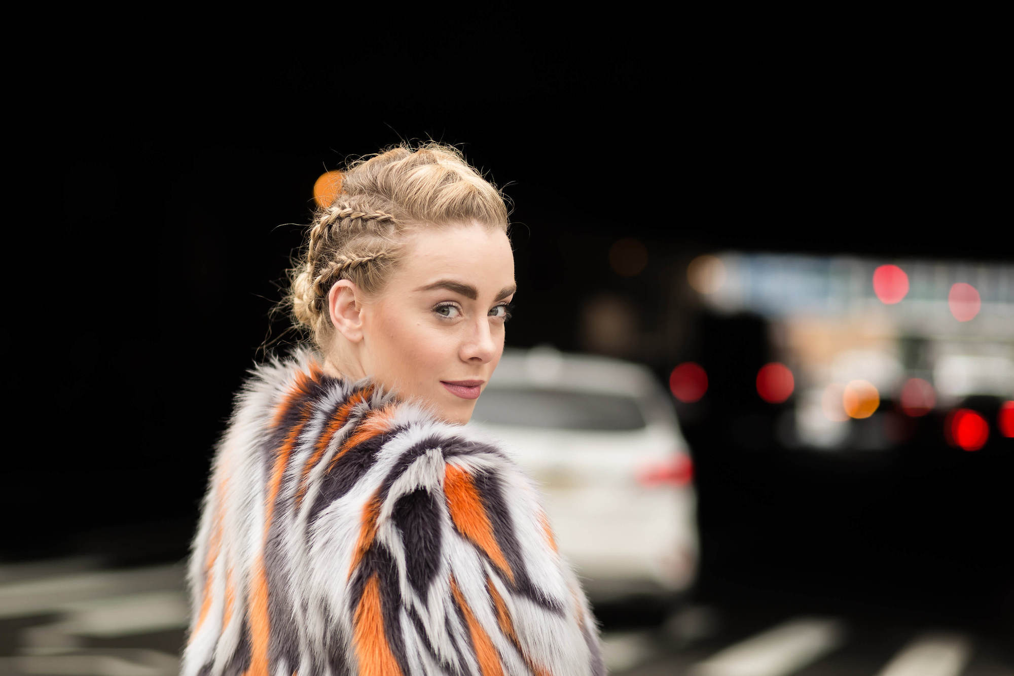 Woman wearing festival braids in an updo.