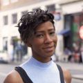 funky short hairstyles as shown by street style model with black curled hair