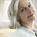 an old lady with short gray hair flipped over smiling forward