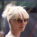 a blonde woman wearing sunglasses with undercut bun