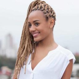 young woman posing with high box braids ponytail style