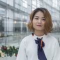 an asian woman with brown short haircut in a lobby