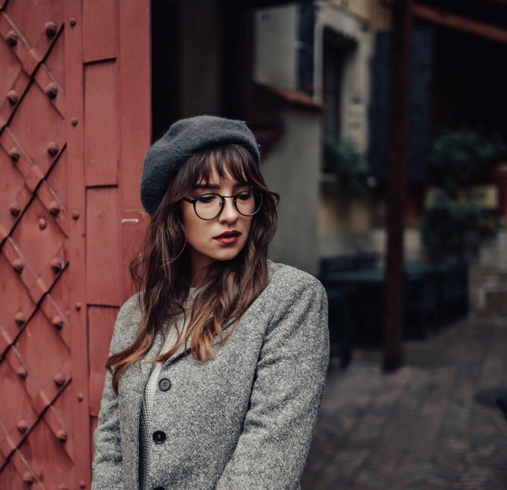 girl with wavy hair wearing a beret