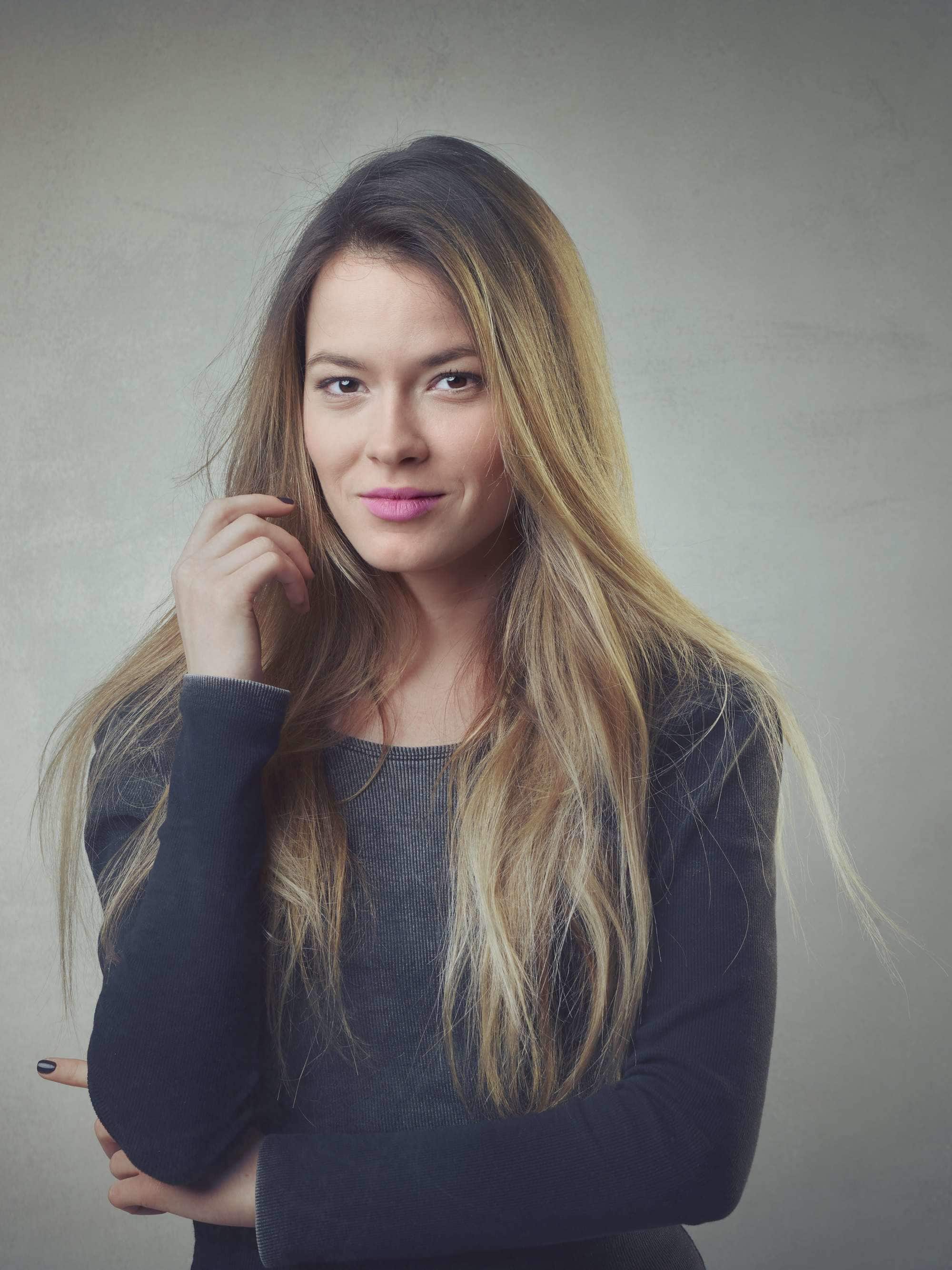 long and grown out blonde hair with dark roots
