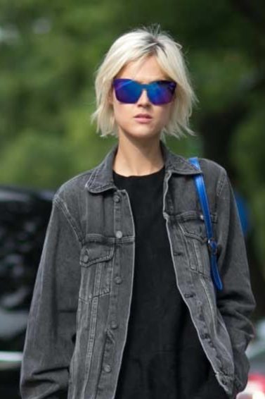 casual look girl wearing denim jacket walking on a street