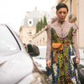 a lovely floral checkered dress worn by a woman walking in the middle of the street