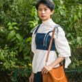 an asian woman with short pixie hair at a park