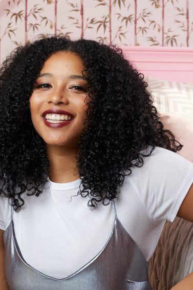 Woman with naturally curly hair smiling