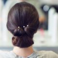 coiffed simple brunette low updo pearls