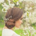 coiffed smooth light brown side updo flowers