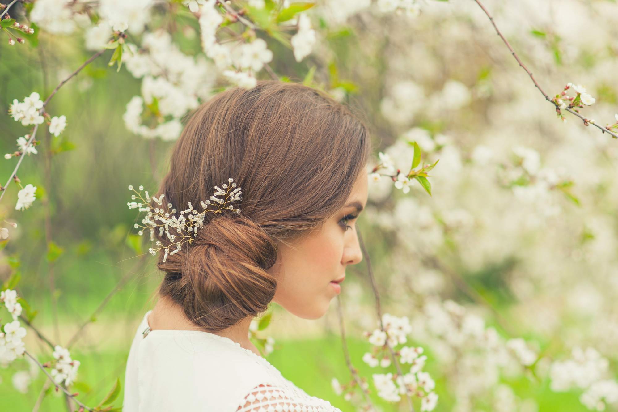 coiffed smooth light brown side updo flowers