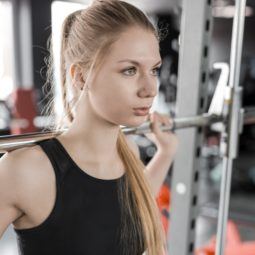 a long blonde hair woman workingout at the gym