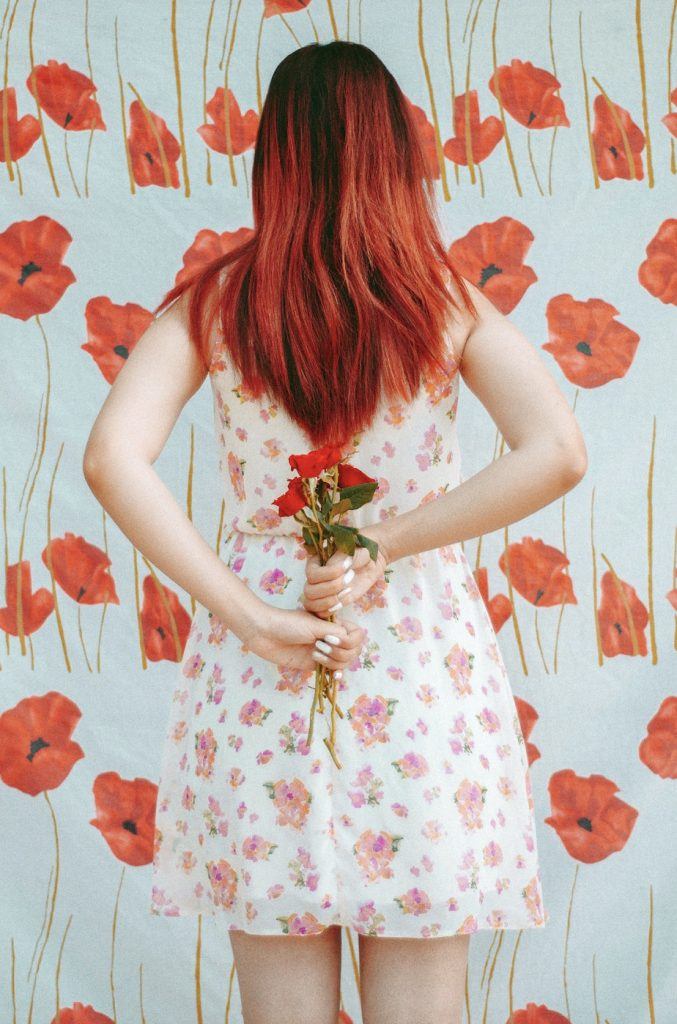 girl with red ombré hair holding flowers