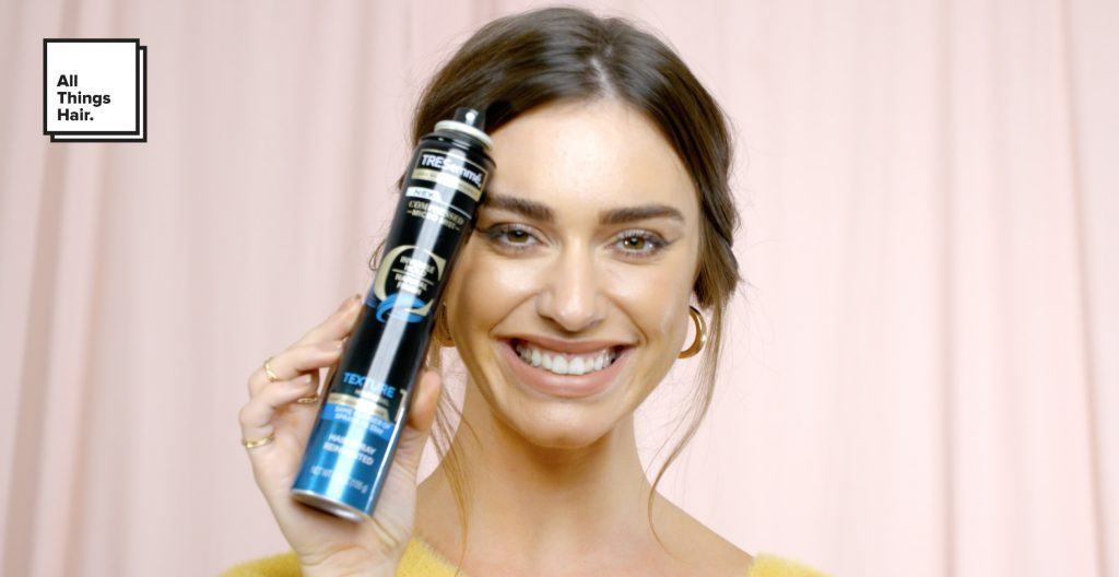 woman holding TRESemmé Compressed Micro Mist Hairspray