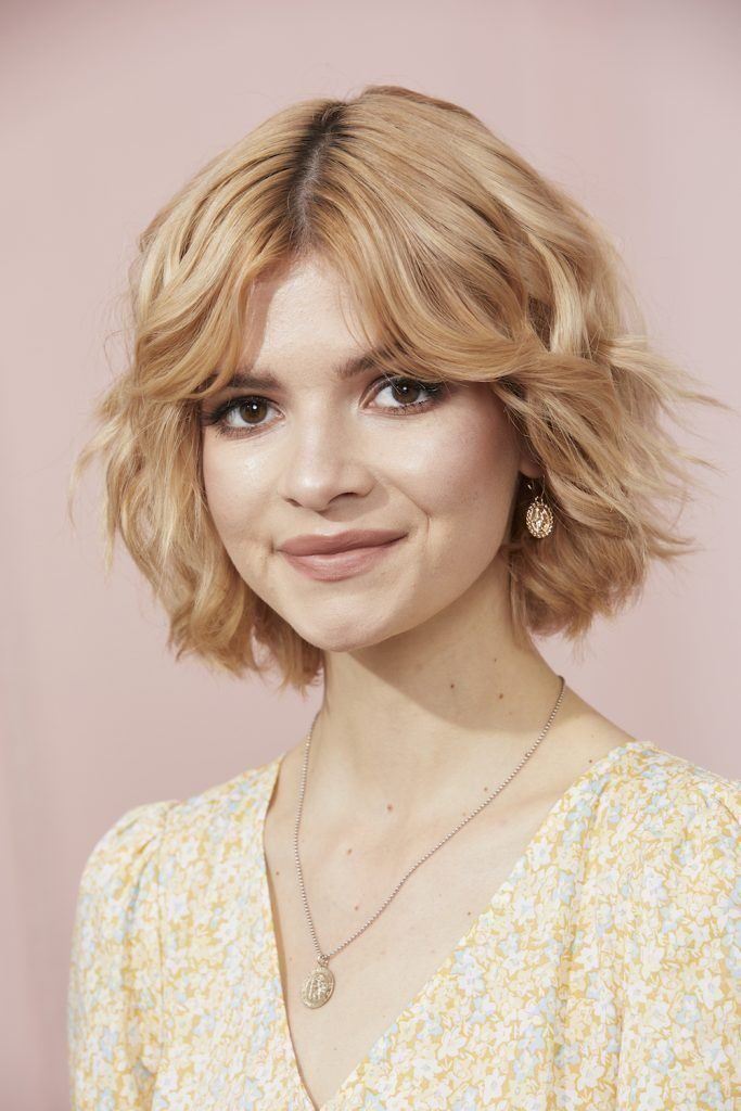 girl with wavy bob and curtain bangs with blonde hair