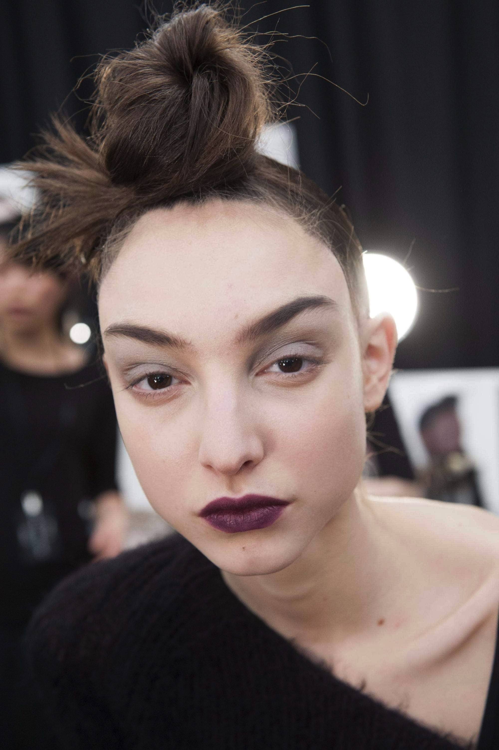 girl with sleek high spiky bun