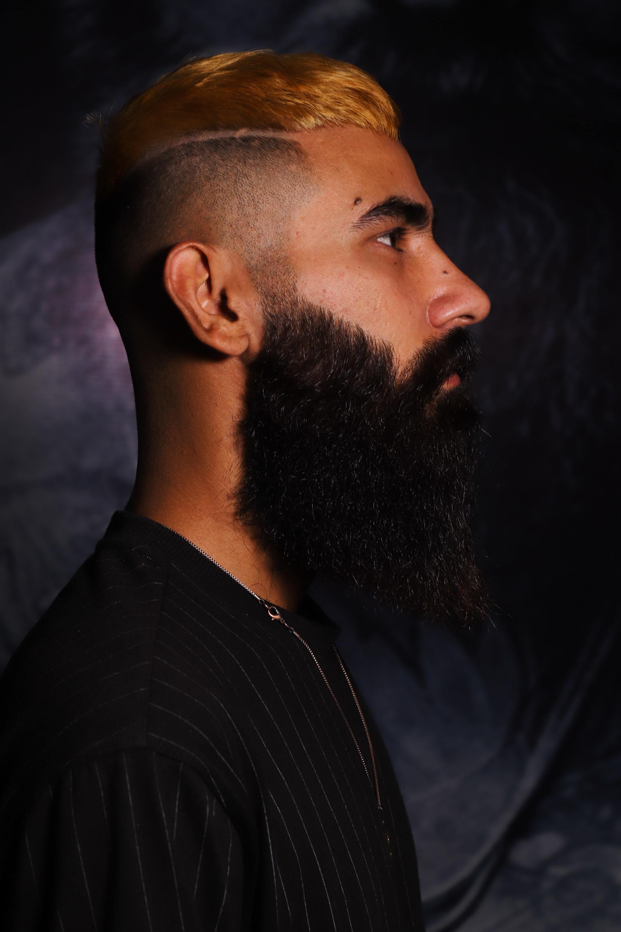 hair shaved on the sides man dark brown yellow hair beard